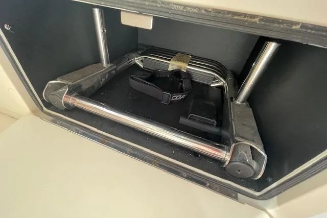 Slide: The Image of Storage compartment in a 2021 Grady-White Freedom 325 boat, featuring a foldable ladder. - 85