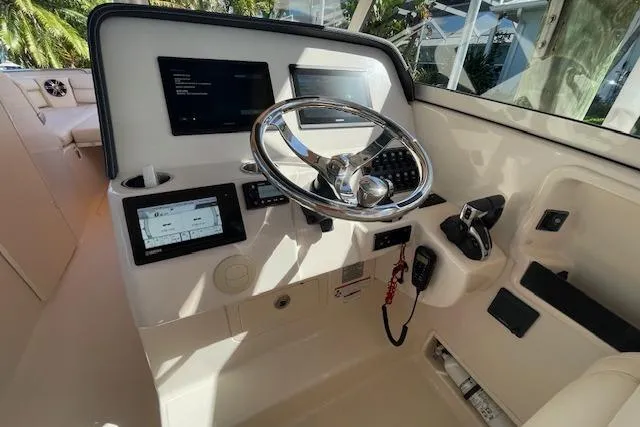 Slide: The Image of 2021 Grady-White Freedom 325 helm with modern controls and navigation displays. - 40