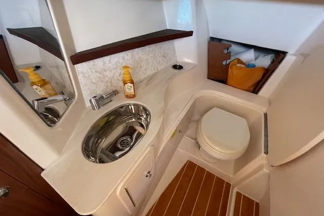Slide: The Image of 2021 Grady-White Freedom 325 boat bathroom with sink, toilet, and wooden flooring. - 56