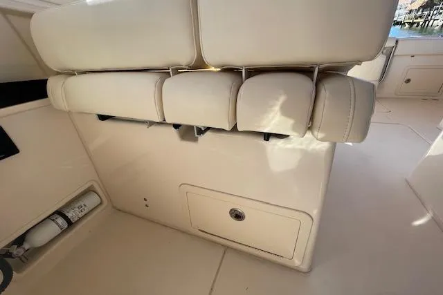 Slide: The Image of 2021 Grady-White Freedom 325 boat interior with beige seating and storage compartment. - 78