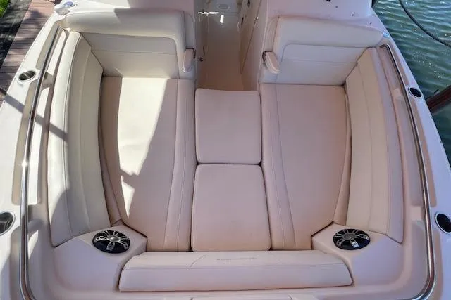 Slide: The Image of 2021 Grady-White Freedom 325 boat interior with beige seating and built-in speakers. - 81