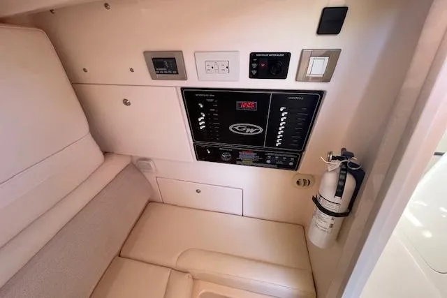 Slide: The Image of 2021 Grady-White Freedom 325 interior control panel with fire extinguisher and seating area. - 61