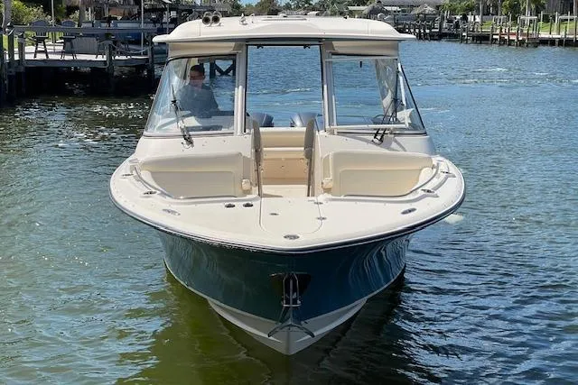 Slide: The Image of 2021 Grady-White Freedom 325 boat on calm water, front view. - 10