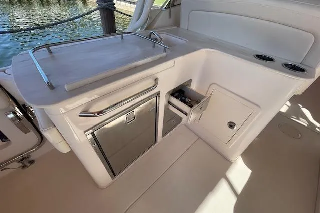 Slide: The Image of 2021 Grady-White Freedom 325 boat interior with kitchenette and storage compartments. - 27