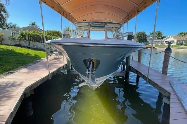 Slide: The Image of 2021 Grady-White Freedom 325 boat docked under canopy in sunny marina setting. - 102