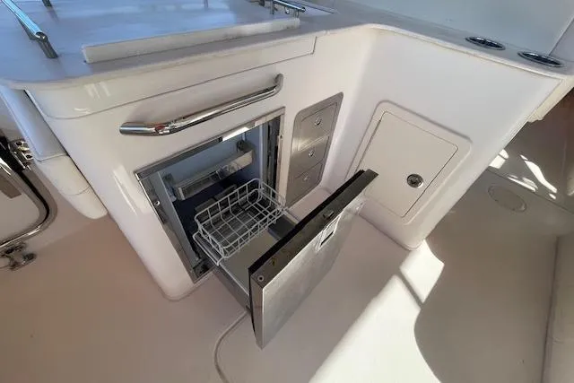 Slide: The Image of 2021 Grady-White Freedom 325 boat interior with open storage compartment. - 26