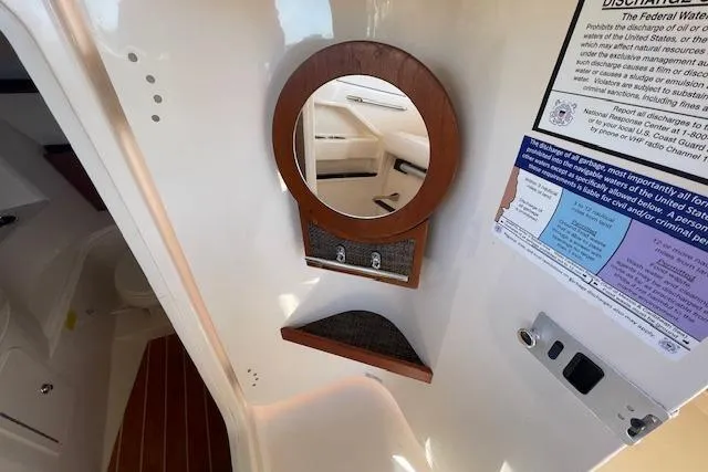 Slide: The Image of Interior of 2021 Grady-White Freedom 325 boat with mirror and informational placards. - 58
