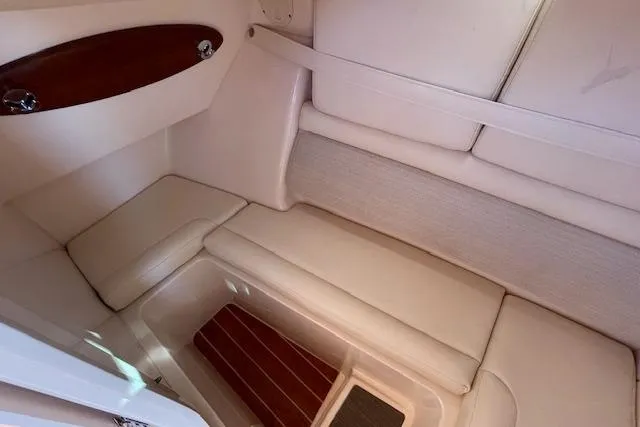 Slide: The Image of 2021 Grady-White Freedom 325 interior cabin with cushioned seating and wood accents. - 59
