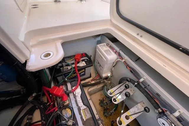 Slide: The Image of Electrical compartment of 2021 Grady-White Freedom 325 boat, featuring batteries and wiring. - 93