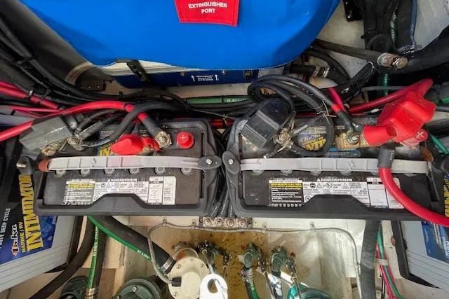 Slide: The Image of Battery compartment of a 2021 Grady-White Freedom 325 boat, featuring dual batteries and wiring. - 92