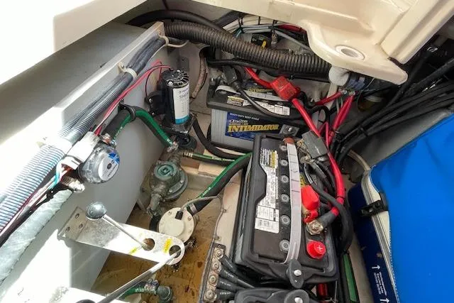 Slide: The Image of Engine compartment of a 2021 Grady-White Freedom 325 boat, showing battery and wiring. - 91