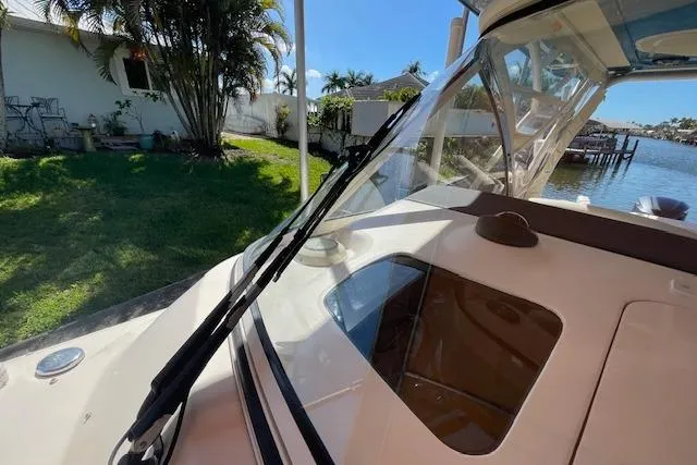 Slide: The Image of 2021 Grady-White Freedom 325 boat docked near waterfront home. - 69