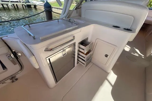 Slide: The Image of 2021 Grady-White Freedom 325 boat interior with kitchenette and storage compartments. - 28