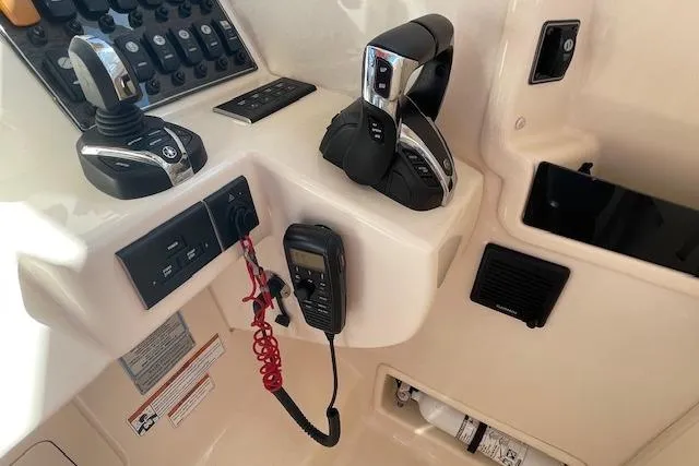 Slide: The Image of Control panel of 2021 Grady-White Freedom 325 boat with throttle and communication devices. - 49