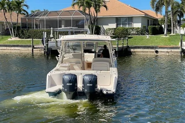 Slide: The Image of 2021 Grady-White Freedom 325 boat cruising near waterfront homes. - 14