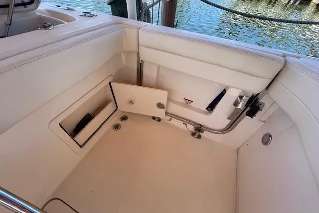 Slide: The Image of 2021 Grady-White Freedom 325 boat interior with open storage compartment. - 24