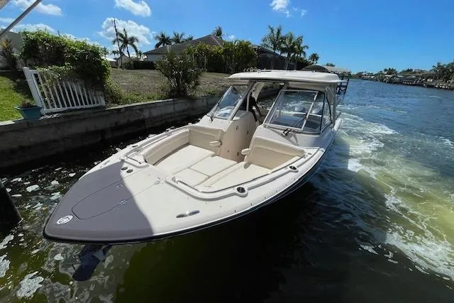 Slide: The Image of 2021 Grady-White Freedom 325 boat on a sunny waterway with palm trees. - 8