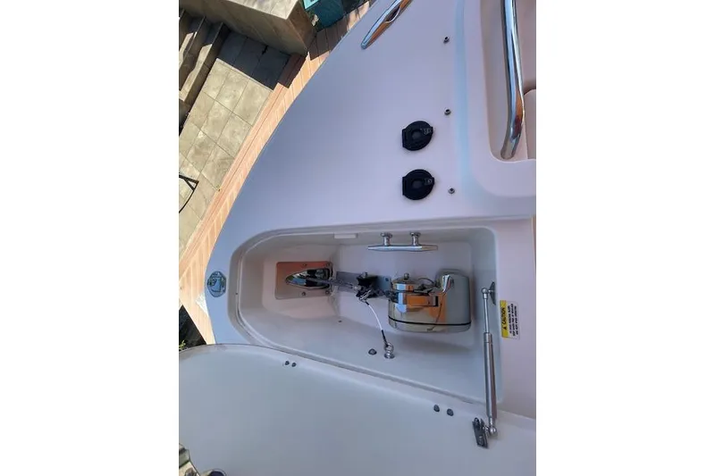 Slide: The Image of 2021 Grady-White Freedom 325 boat anchor compartment with stainless steel fittings. - 83
