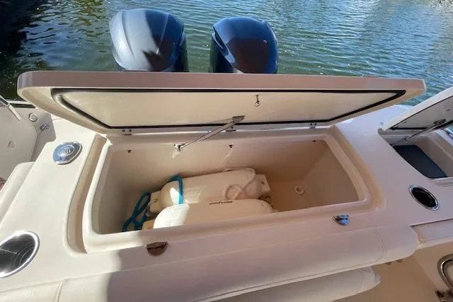 Slide: The Image of Open storage compartment on 2021 Grady-White Freedom 325 boat, with fenders inside. - 29