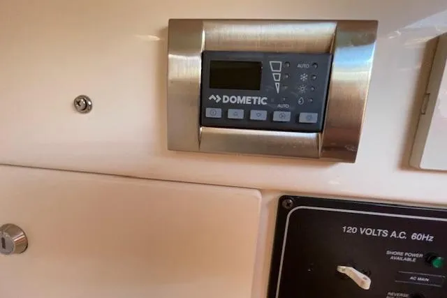 Slide: The Image of Control panel on a 2021 Grady-White Freedom 325 boat, featuring Dometic system. - 63