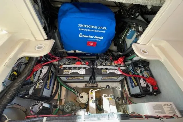 Slide: The Image of Engine compartment of 2021 Grady-White Freedom 325 with batteries and Fischer Panda generator. - 89