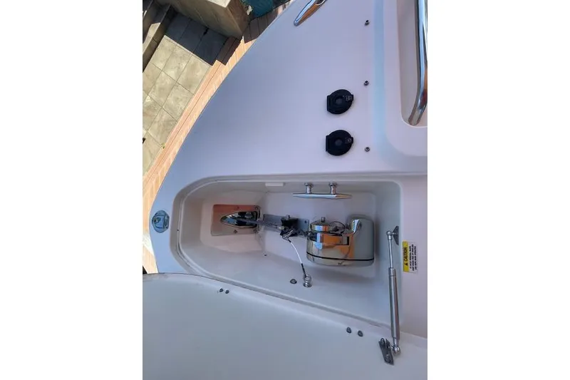Slide: The Image of 2021 Grady-White Freedom 325 boat anchor compartment with winch and controls. - 84