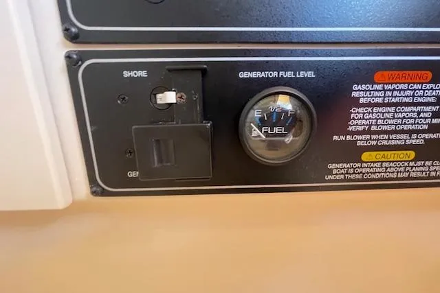 Slide: The Image of Control panel of a 2021 Grady-White Freedom 325 boat, showing generator fuel level gauge. - 66