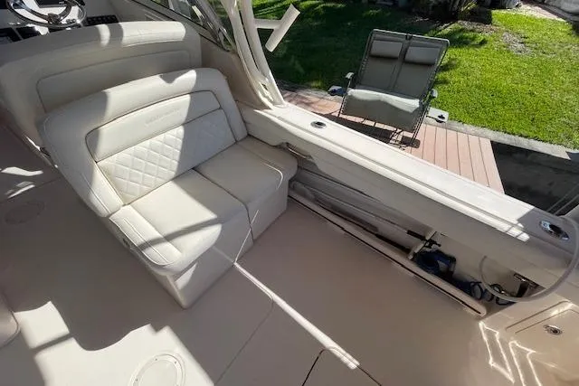 Slide: The Image of 2021 Grady-White Freedom 325 boat interior with cream seating and outdoor view. - 31
