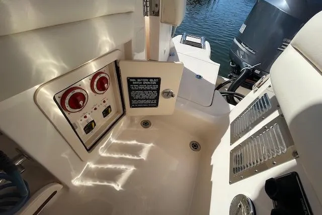 Slide: The Image of 2021 Grady-White Freedom 325 boat controls and engine area, featuring dual outboard motors. - 20