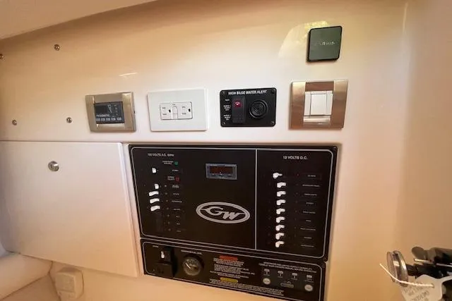 Slide: The Image of Control panel of 2021 Grady-White Freedom 325 boat with various switches and alerts. - 62