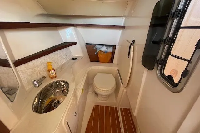 Slide: The Image of 2021 Grady-White Freedom 325 boat bathroom with sink, toilet, and window. - 55
