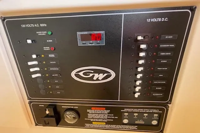 Slide: The Image of Control panel of a 2021 Grady-White Freedom 325 boat, featuring 120V AC and 12V DC systems. - 65