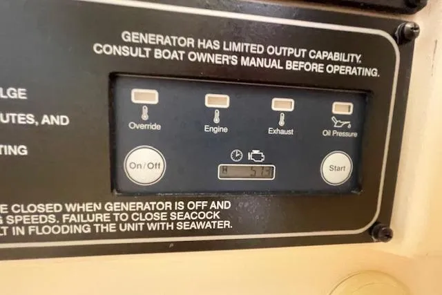 Slide: The Image of Control panel of a 2021 Grady-White Freedom 325 boat generator with various function buttons. - 67