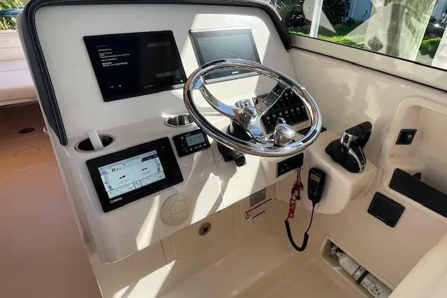 Slide: The Image of Helm of 2021 Grady-White Freedom 325 boat with modern controls and steering wheel. - 41