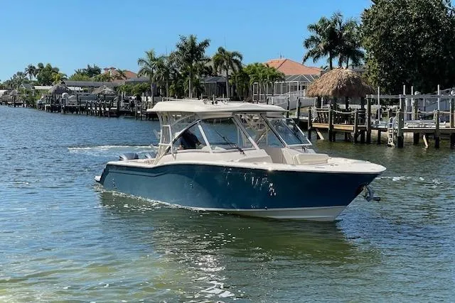 The Image of A 2021 Grady-White Freedom 325 boat cruising on a calm waterway. - 0