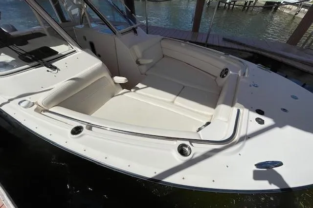 Slide: The Image of 2021 Grady-White Freedom 325 boat with spacious seating area, docked by the water. - 12