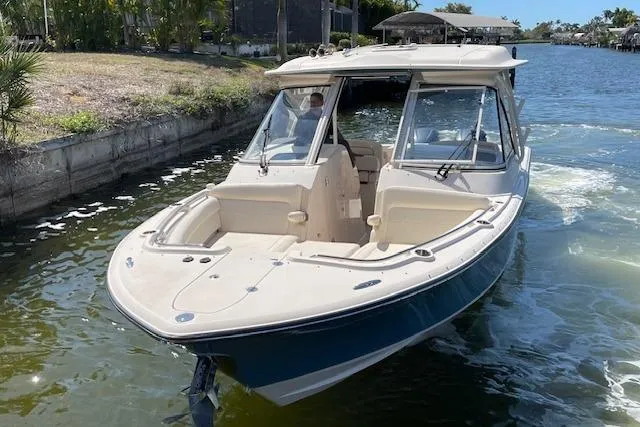 Slide: The Image of 2021 Grady-White Freedom 325 boat cruising on a sunny waterway. - 7