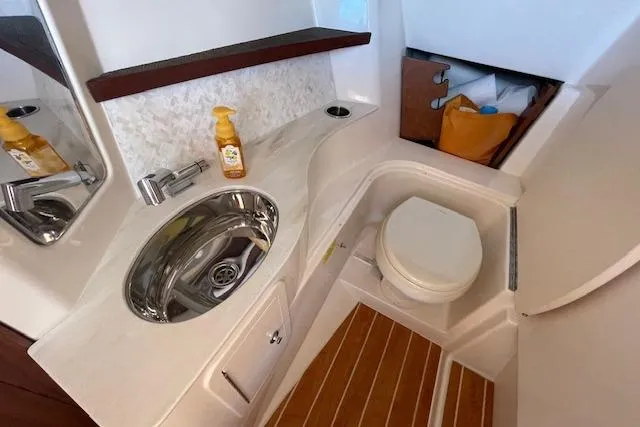 Slide: The Image of 2021 Grady-White Freedom 325 boat bathroom with sink, toilet, and wooden flooring. - 57