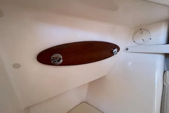 Slide: The Image of Interior detail of 2021 Grady-White Freedom 325 boat, featuring wooden panel and fixtures. - 68