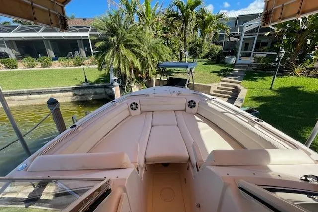 Slide: The Image of 2021 Grady-White Freedom 325 boat docked near lush garden and waterfront home. - 79