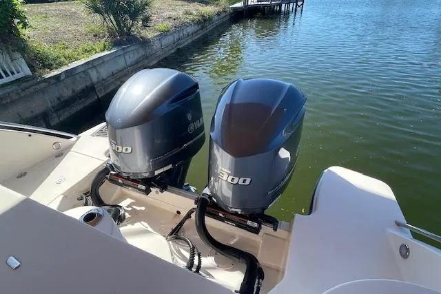 Slide: The Image of 2021 Grady-White Freedom 325 boat with twin Yamaha 300 outboard engines on a calm waterway. - 16