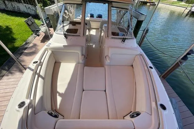 Slide: The Image of 2021 Grady-White Freedom 325 boat with spacious seating, docked by the water. - 80