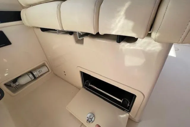Slide: The Image of 2021 Grady-White Freedom 325 boat interior with storage compartment and fire extinguisher. - 86