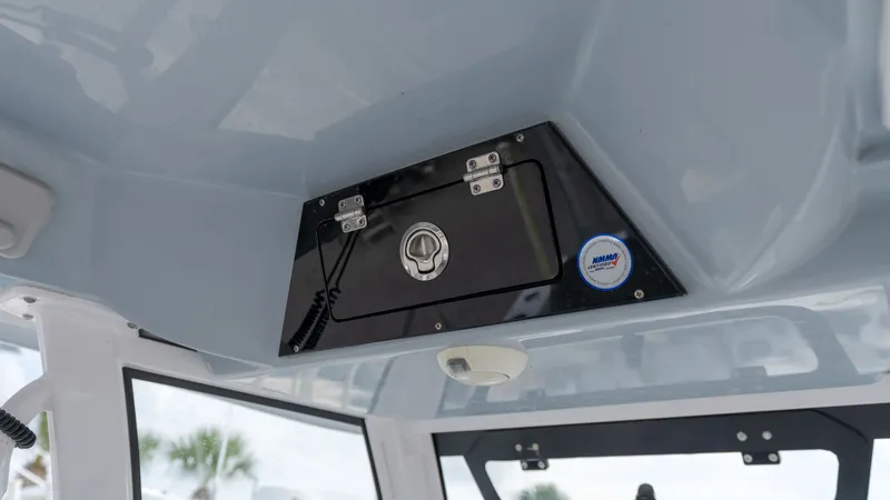 Slide: The Image of A black compartment with a lock is mounted on a boat's ceiling. - 18