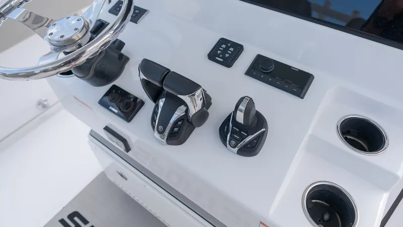 Slide: The Image of Close-up of the helm of a Sportsman Open 282TE Center Console boat with modern controls. - 24