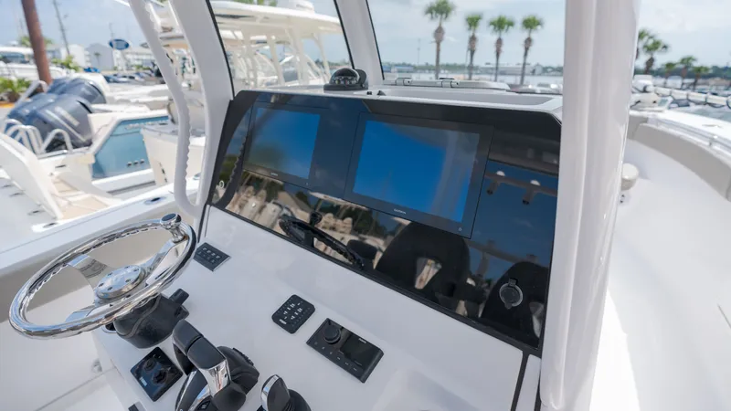 Slide: The Image of The image shows the cockpit of a 2023 Sportsman Open 282TE Center Console boat with modern instruments. - 19