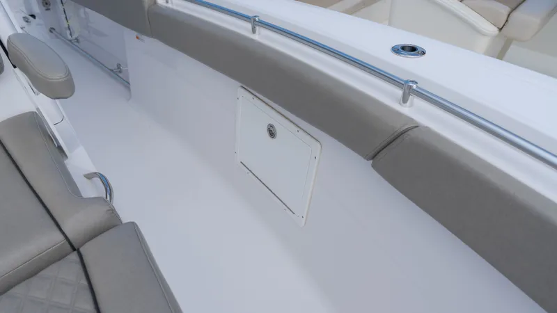 Slide: The Image of The image shows the interior of a Sportsman Open 282TE Center Console boat with gray upholstery. - 14