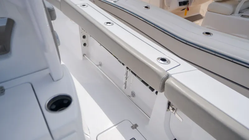 Slide: The Image of Interior view of a Sportsman Open 282TE Center Console boat with white and gray seating. - 27