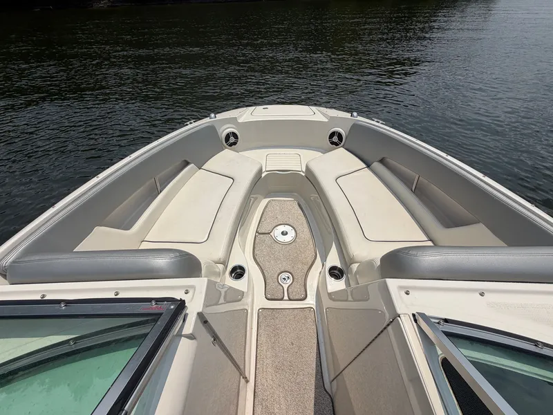 Slide: The Image of The image shows the bow of a 2009 Sea Ray 230 Sundeck boat with beige seating. - 6