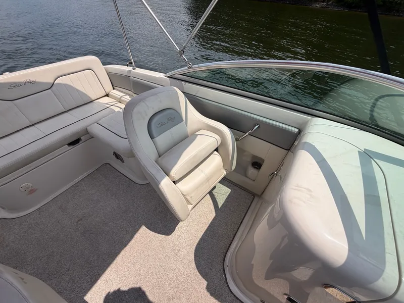 Slide: The Image of The image shows the cockpit of a 2009 Sea Ray 230 Sundeck boat with beige seating. - 9